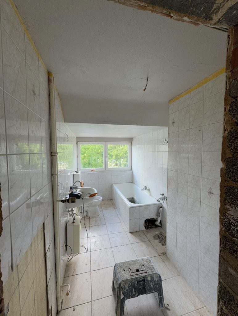 Chaotisches und dreckiges Bad vor Renovierungsarbeiten